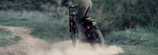 person riding electric bike on dirt trail in outdoor natural setting