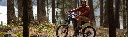 man riding electric mountain bike in forest showing electric bicycle fault codes guide