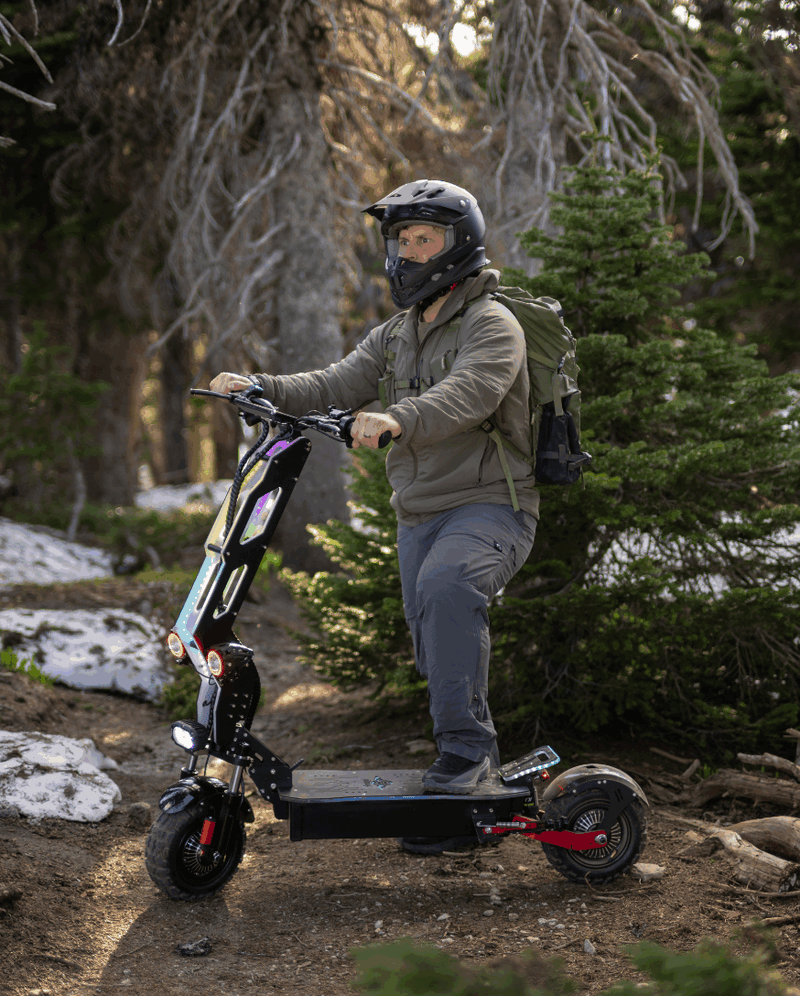 Rider on Freego D11 electric scooter in a forest trail