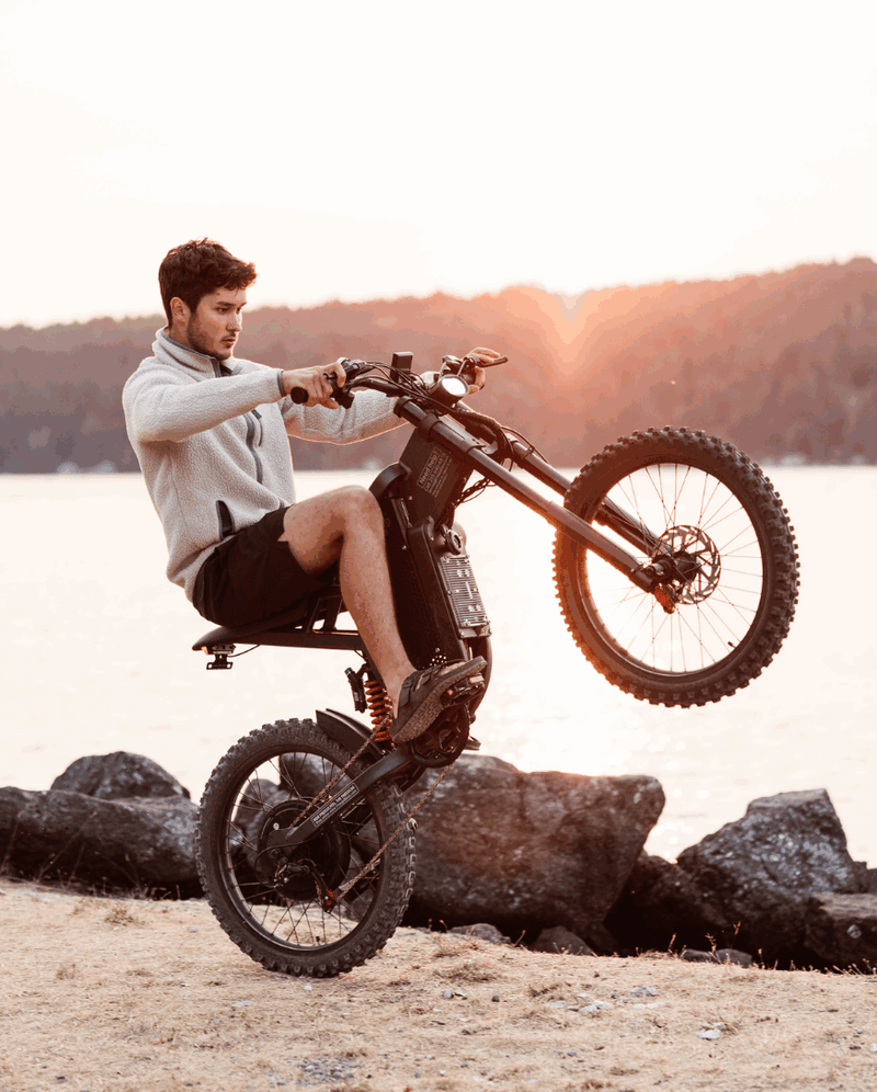 Man riding Freego X2 by the water at sunset