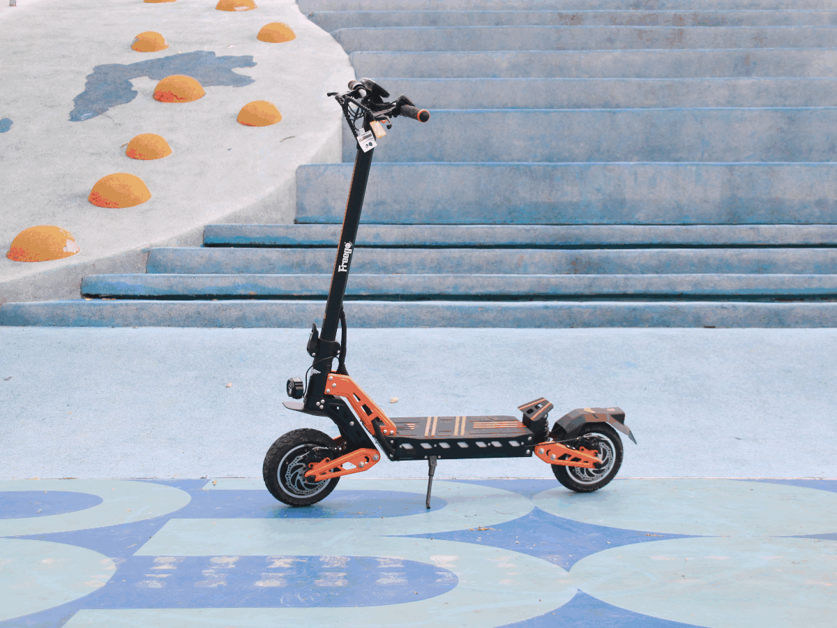 Orange and black electric scooter on a blue and white outdoor floor