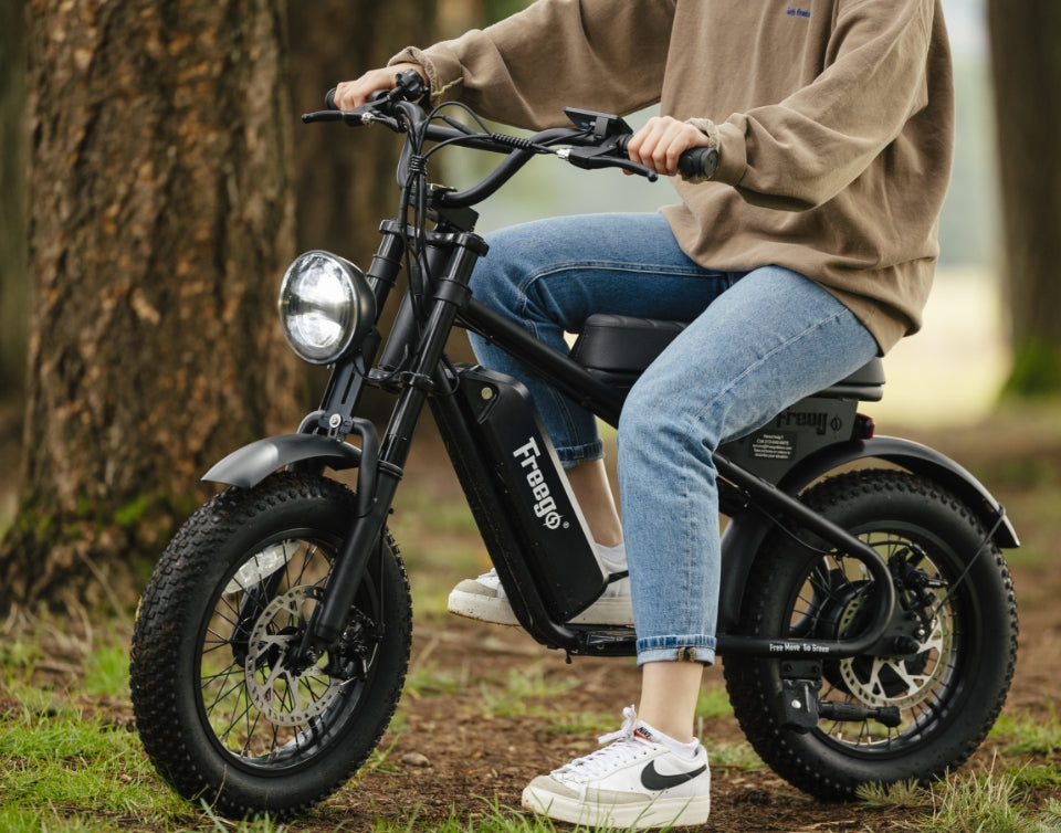 Close-up of a rider on a Freego e-bike in a forest setting