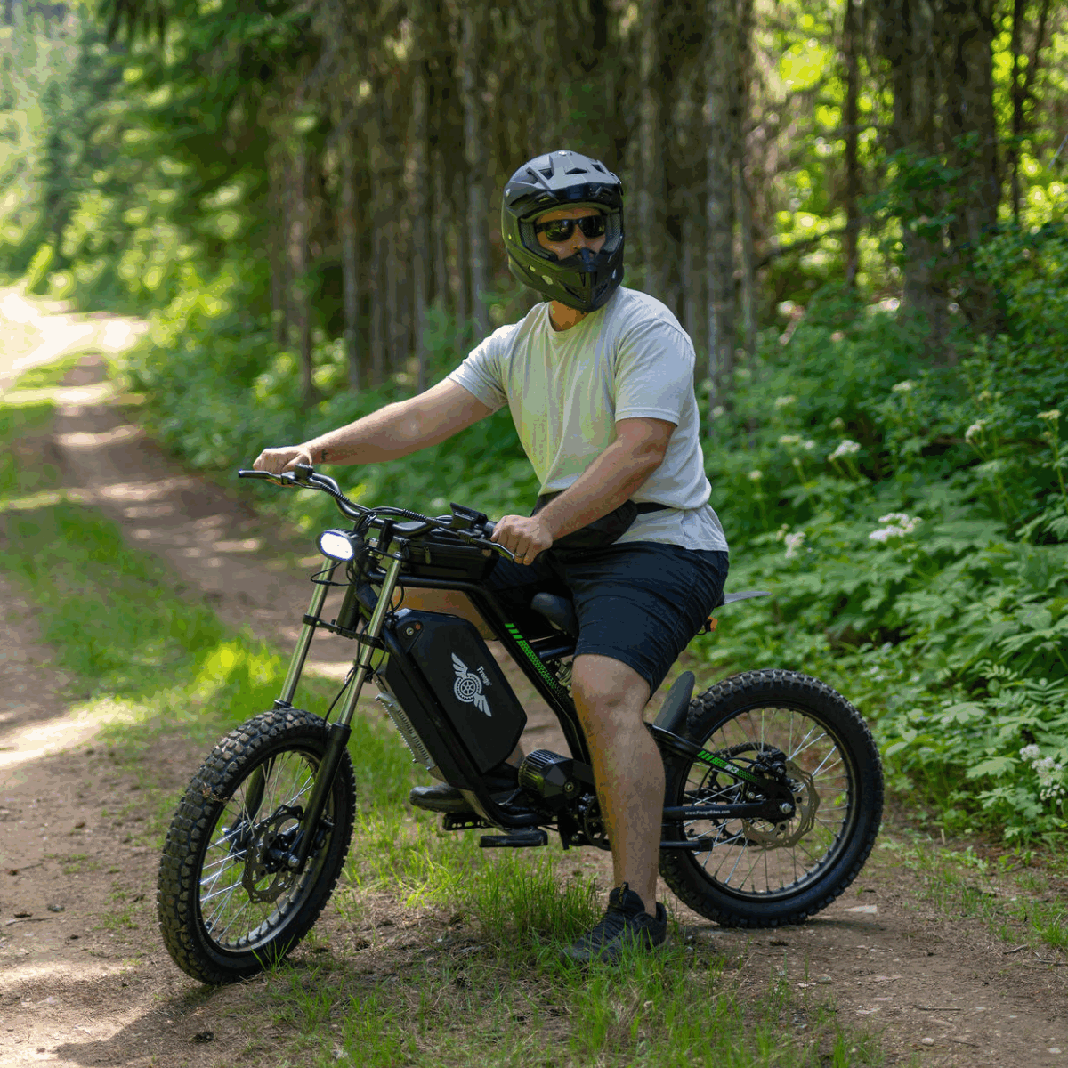 Man riding an Nova 3 electric bike on a forest path