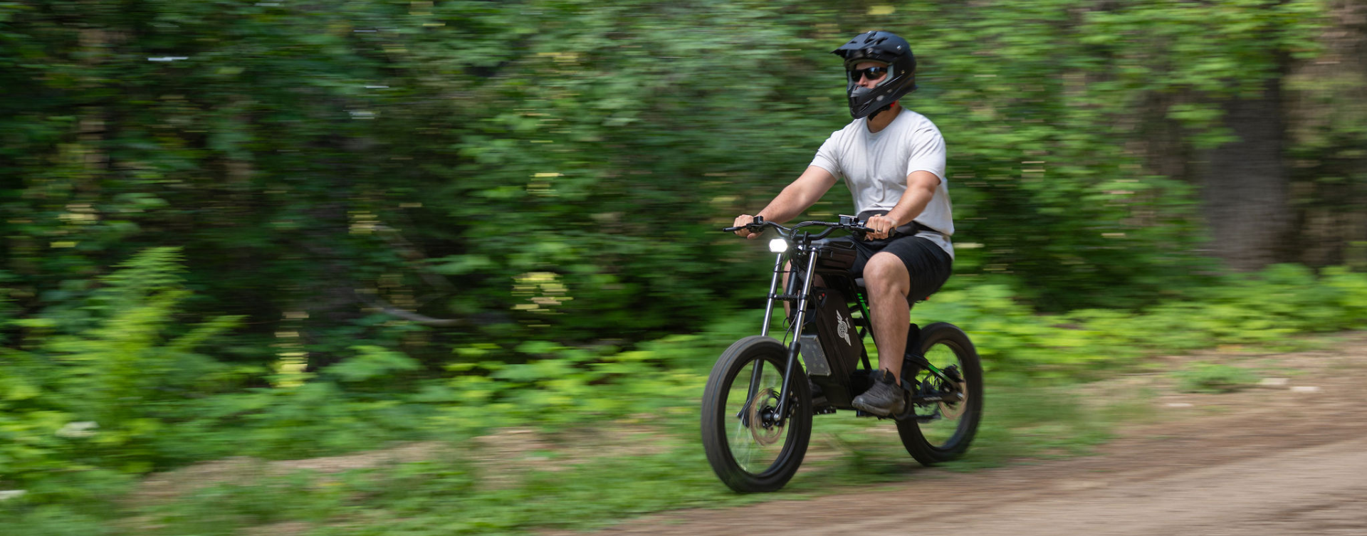 Freego Nova 3 mid-drive eBike riding on a rugged mountain trail