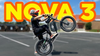 Person riding a bike with 'NOVA 3' branding in a parking lot.