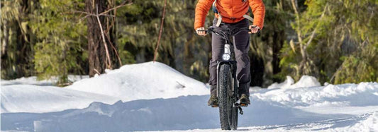 Fat Tire electric bike riding on snowy trail for hunting with wide tires and stable terrain handling