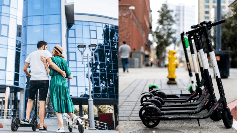 Row of parked electric scooters on city sidewalk and couple walking nearby in urban setting