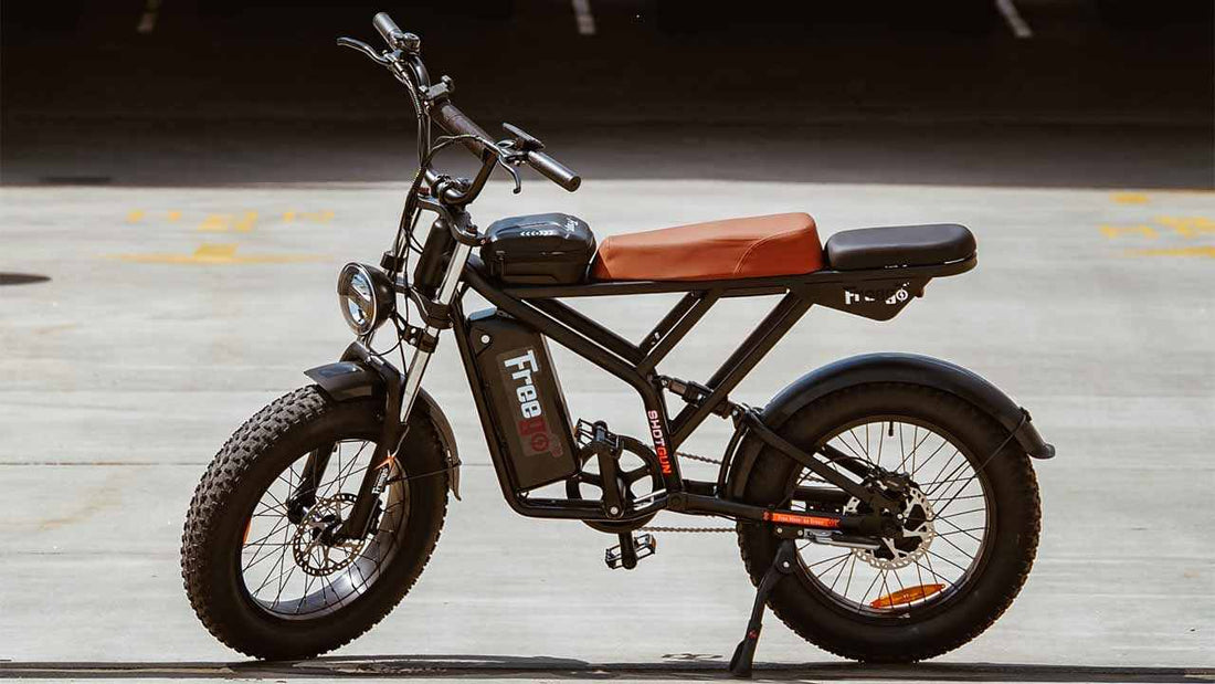 black electric bicycle with brown seat parked on concrete floor in outdoor setting