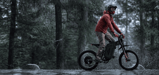 A rider riding a Freego X2 Pro through a rainy forest trail, showcasing off-road performance and all-weather adventure capability - ride an eBike in the rain.