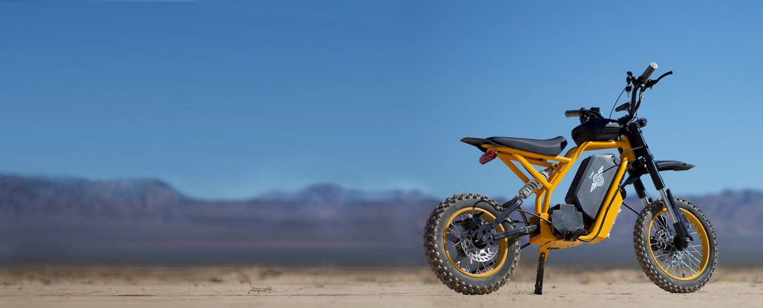 Stylish black&yellow Freego Electric Bike Nova 2 parked under the clear sky of a desert