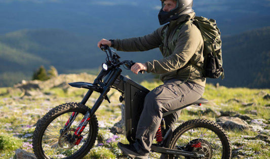 A rider on a high-performance Freego X2 Pro electric bike traversing a scenic mountain ridge overlooking the Southern California landscape.