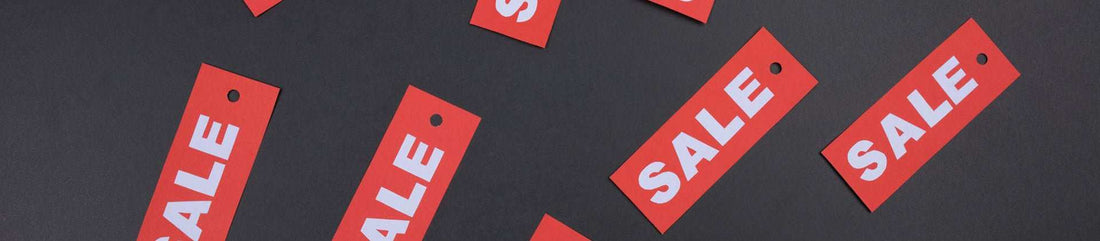 Red sale tags on dark background for Freego Bikes discounts and coupons promotion