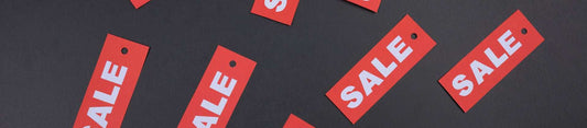 Red sale tags on dark background for Freego Bikes discounts and coupons promotion