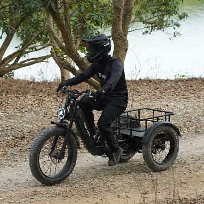 Person riding a freego flextrike swing on a dirt path with trees and water in the background