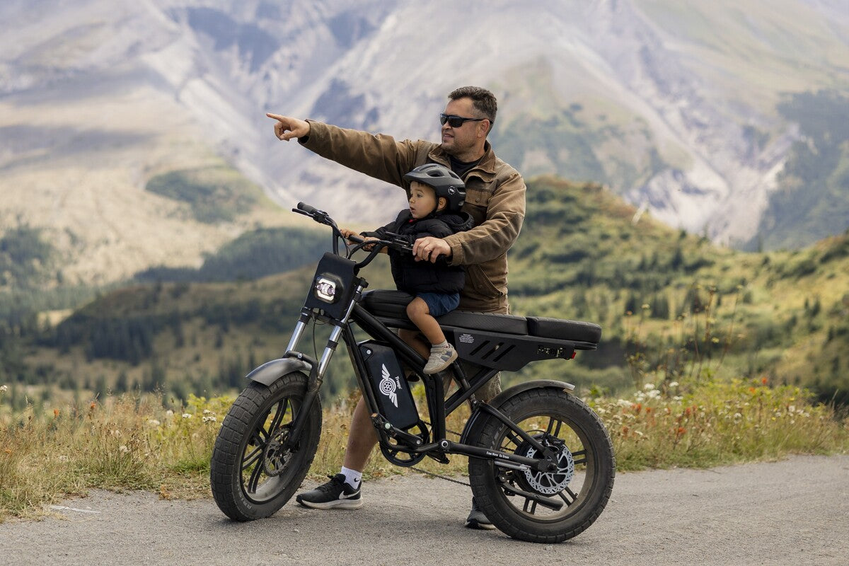 Man and child on a Freego-F2-pro-max in a mountainous landscape