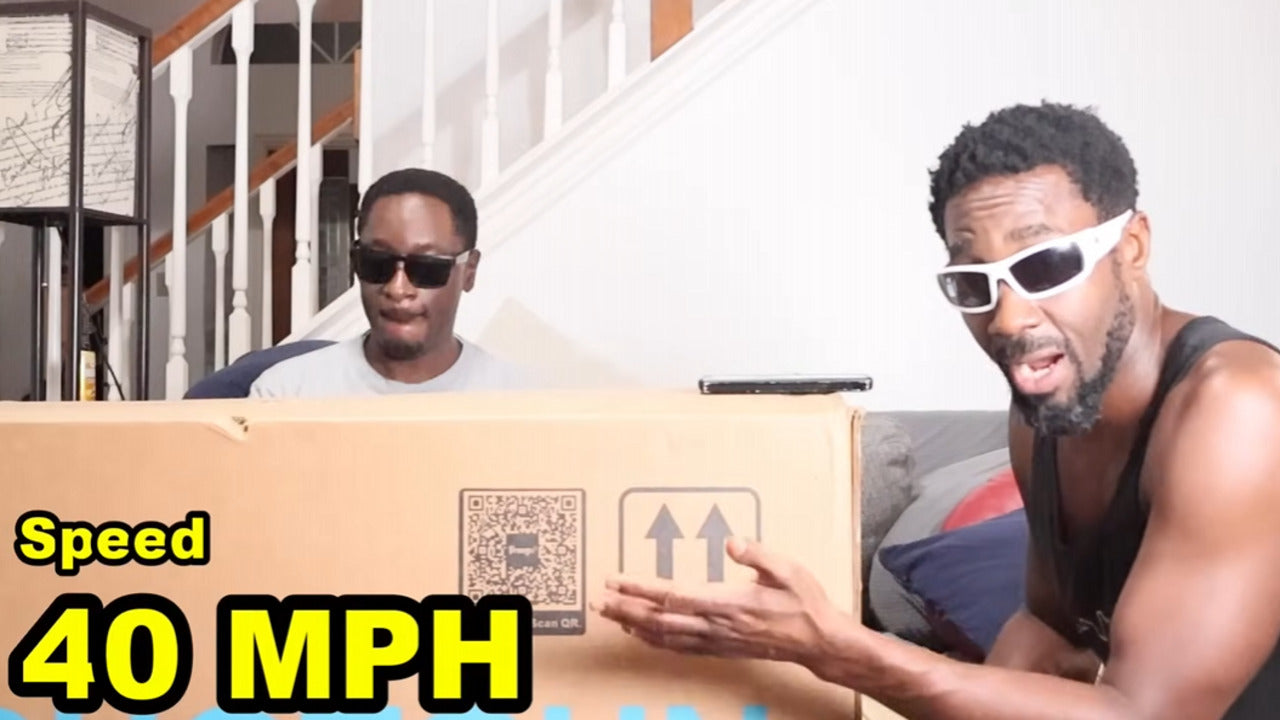 Two men holding a box with 'Speed 40 MPH' text for Freego F2 pro max