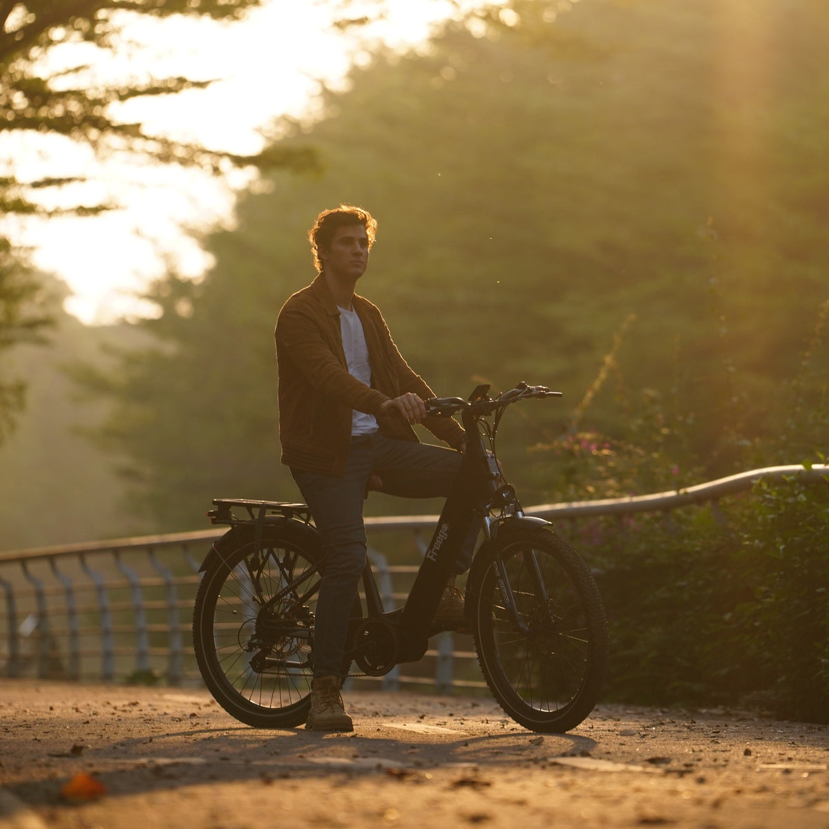 Man riding freego A1 on a path with a blurred natural background