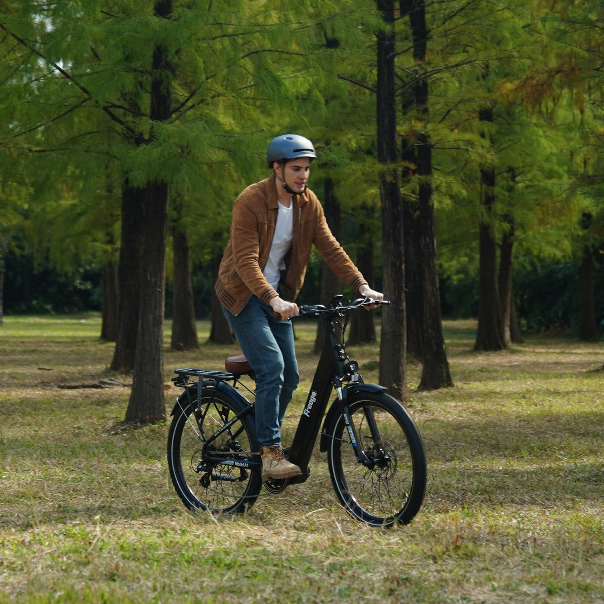 Man riding freego A1 in a park with trees in the background