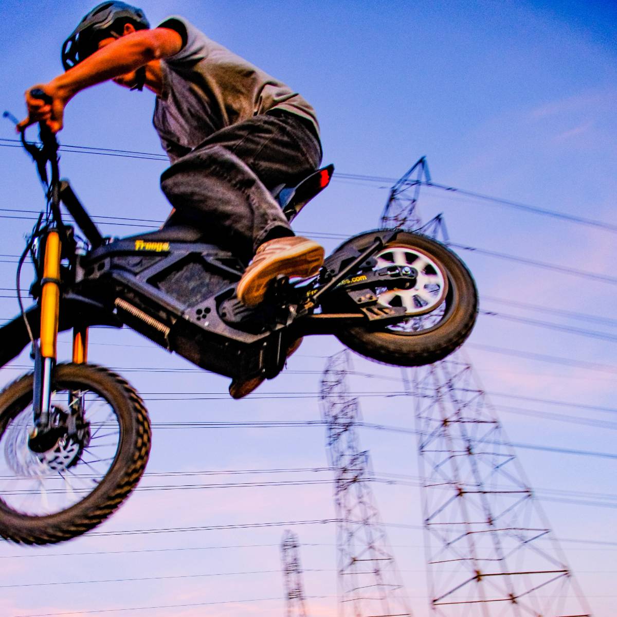 Low angle view of a rider jumping the Freego Nova 5 Mini during an off-road ride.