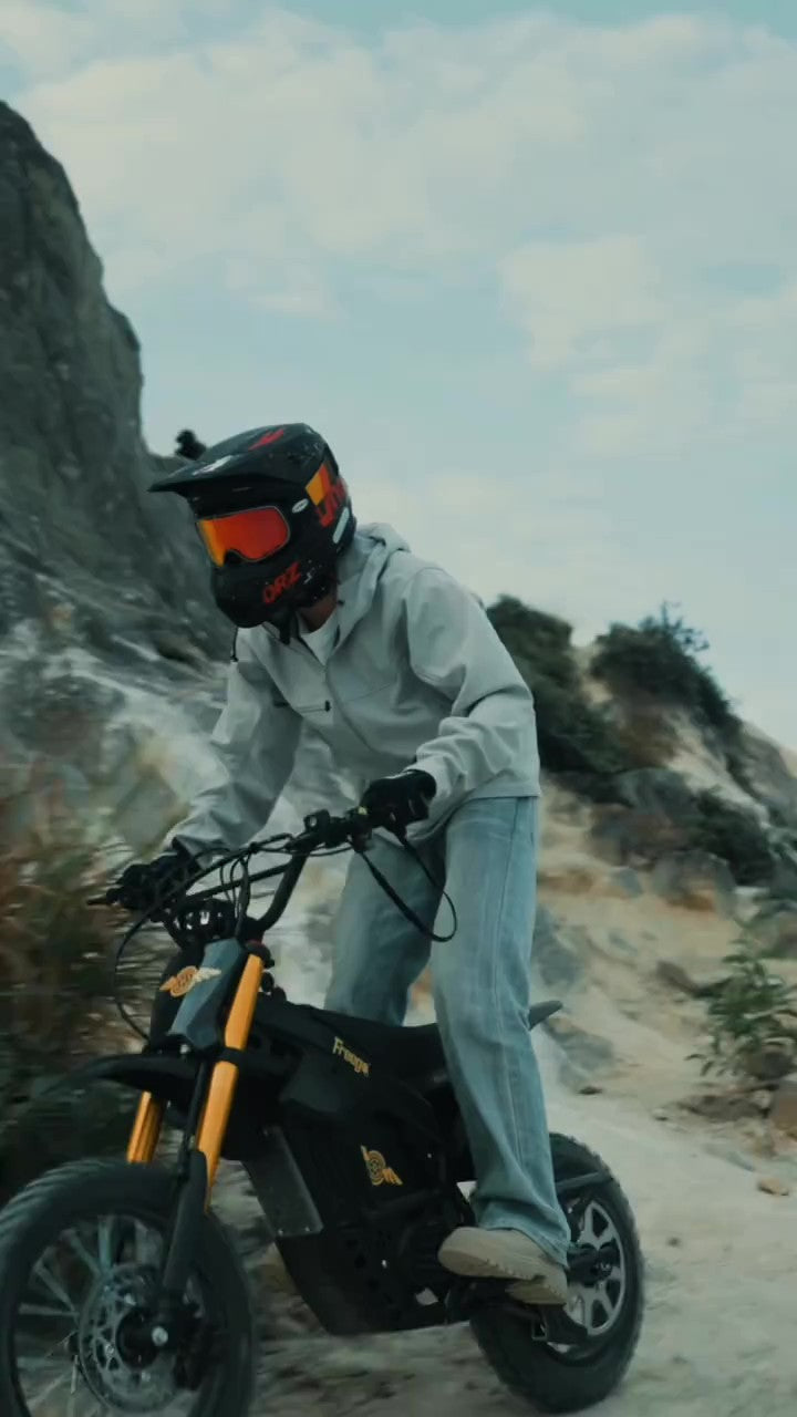 Person riding a freego nova 5 mini on a rocky trail with a helmet on