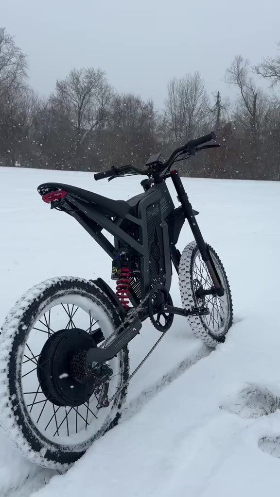 Electric bike on a snowy landscape with trees in the background