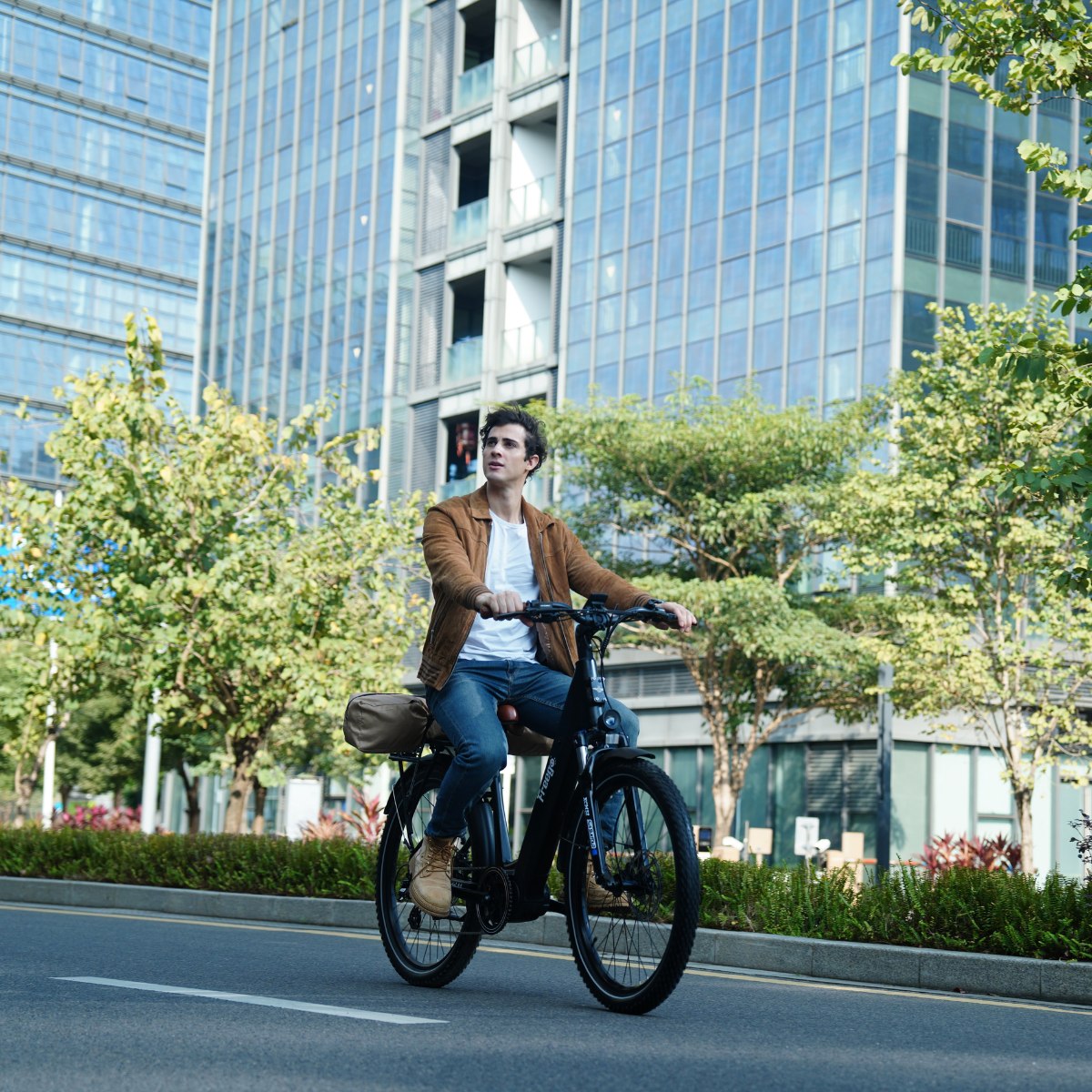Man riding a Freego City Flow A1 Electric Bike on a city street with modern buildings in the background