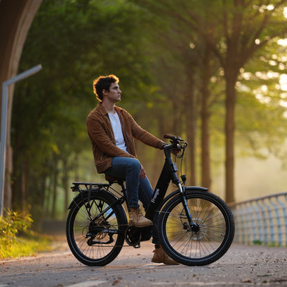 Man riding a Freego City Flow A1 Electric Bike on a path with trees in the background