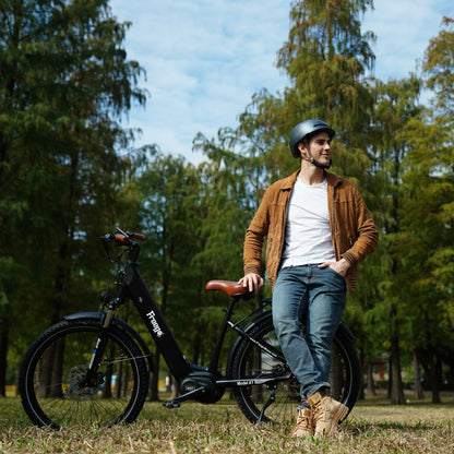 Man standing next to a black Freego City Flow A1 Electric Bike in a park