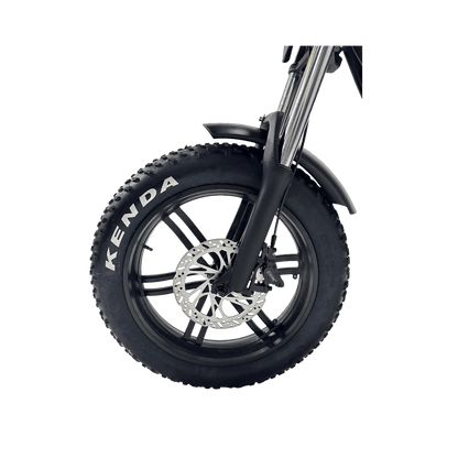 Close-up of a Kenda tire on a bike with a gray background