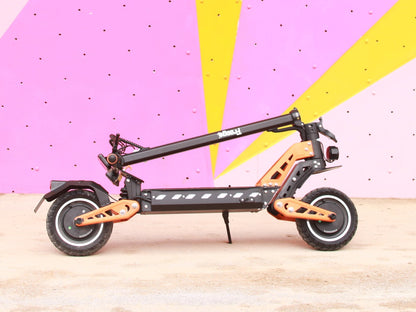 Orange and black electric scooter on a pink and yellow abstract background