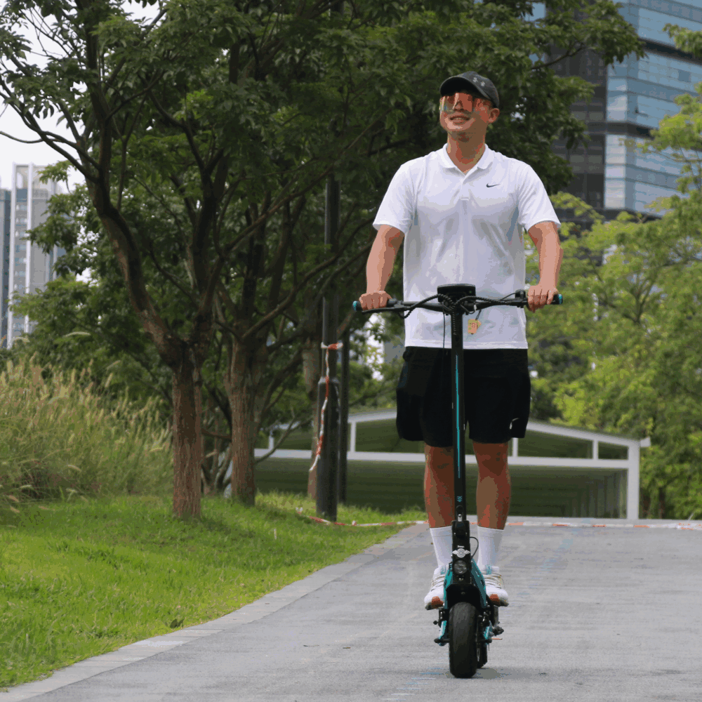 Freego C10 E-Scooter person riding greenery scene