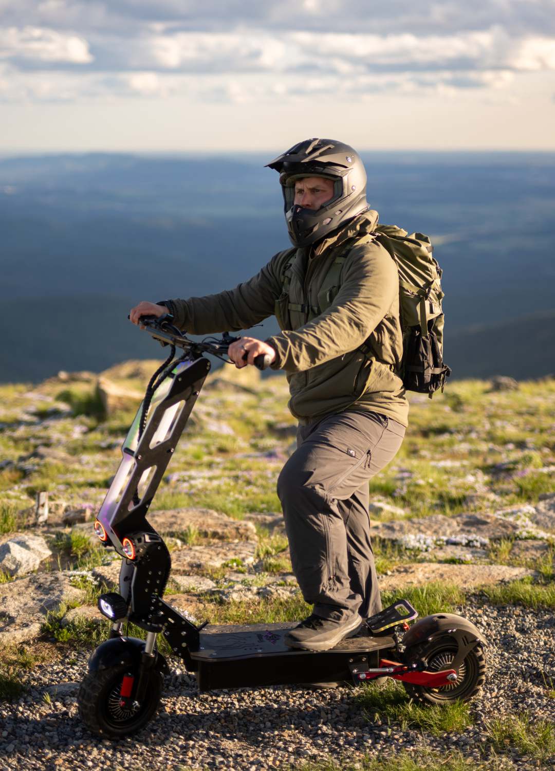 A rider exploring rocky outdoor terrain on a Freego electric scooter, showcasing its off-road capability, durable design, and performance on uneven surfaces.