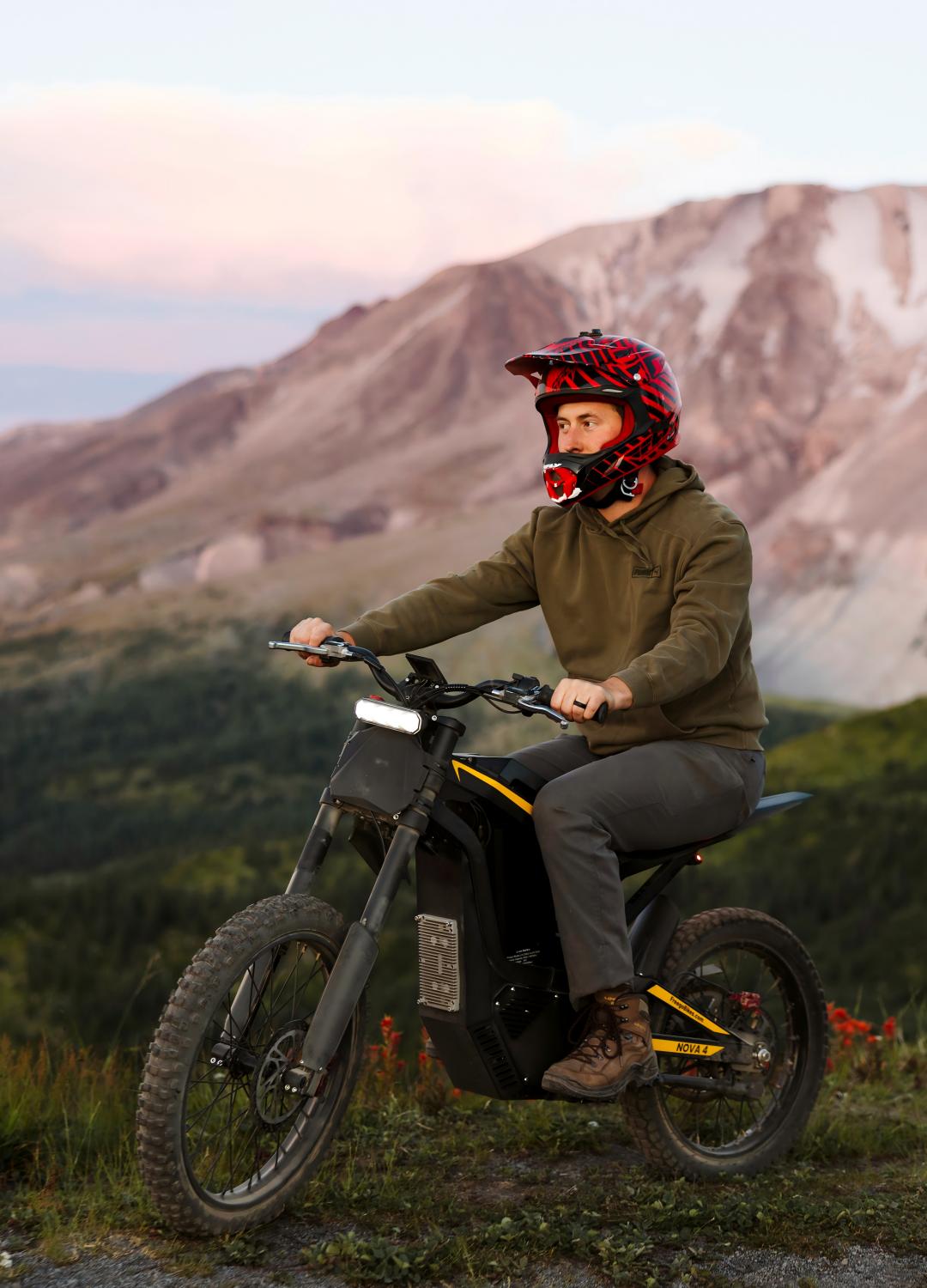 A rider exploring an outdoor mountain trail on a Freego electric dirt bike, showcasing its off-road performance, fat tire design, and adventure-ready capability.