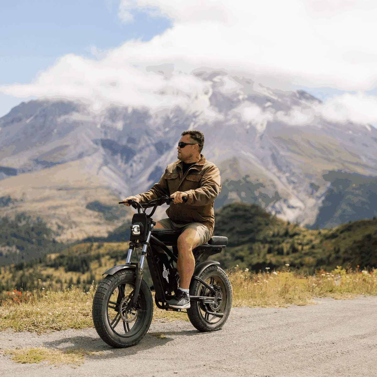 Man riding a motorcycle in a mountainous landscape