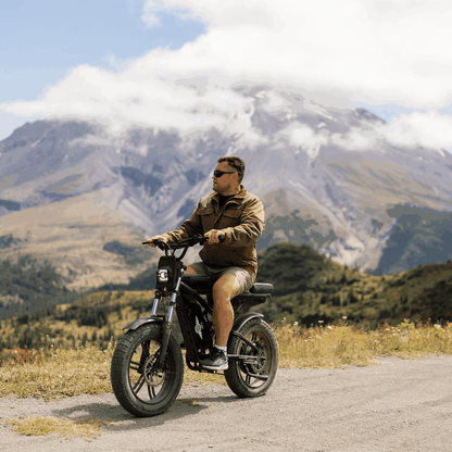 Man riding a motorcycle in a mountainous landscape