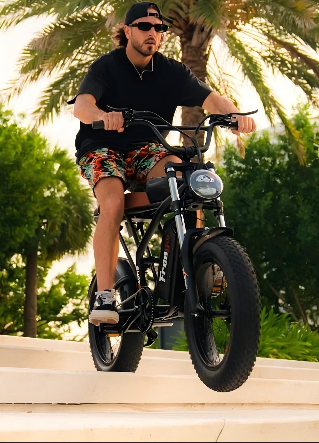 A rider cruising on a Freego fat tire electric bike in an outdoor setting, showcasing its wide tires, comfortable design, and versatile all-terrain riding capability.