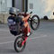 Action shot of TikTok influencer lamontson performing wheelie stunt on Freego electric bike in outdoor parking lot
