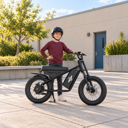Child wearing a helmet standing beside a black Freego M1-Neo mini electric motorcycle in a sunny courtyard.