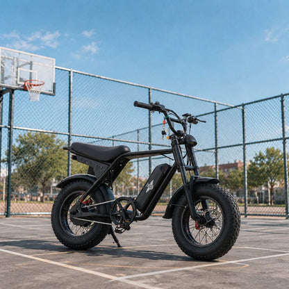 Freego M3 fat tire e-bike parked on an urban outdoor basketball court