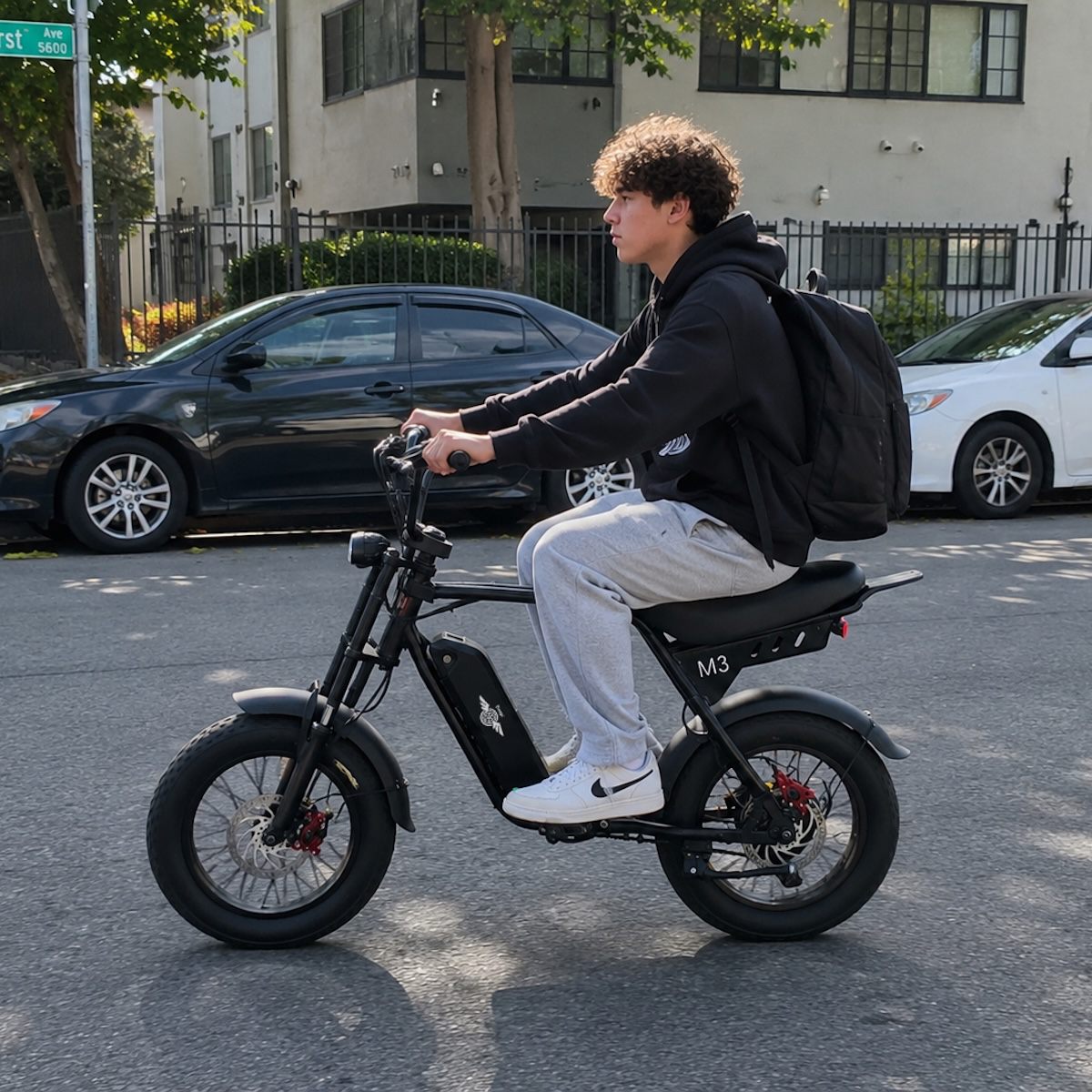 Young rider commuting on a Freego M3 fat tire e-bike with a backpack