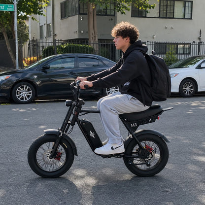 Young rider commuting on a Freego M3 fat tire e-bike with a backpack
