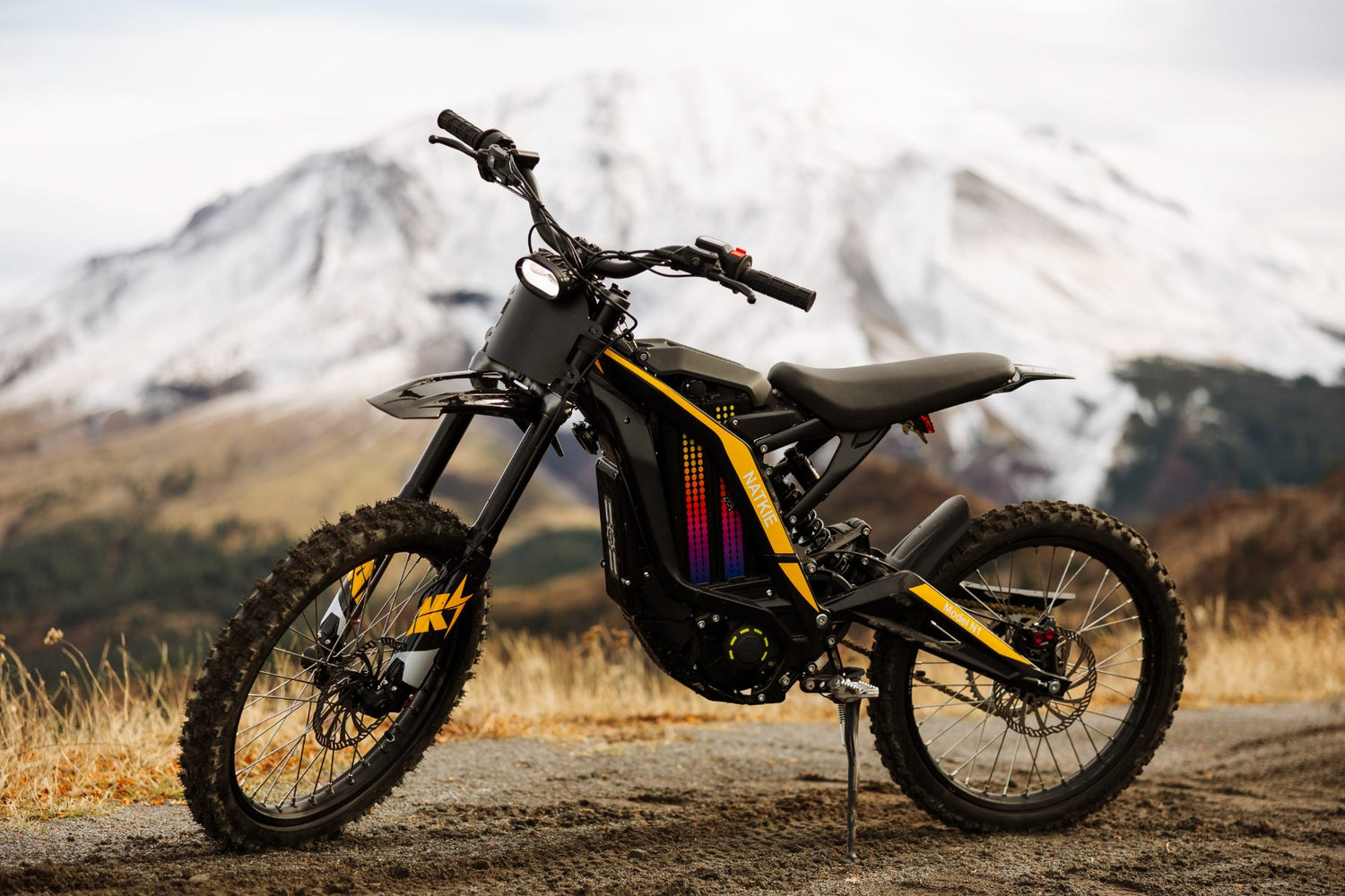 Freego N1 Electric bike with colorful design on a dirt path with mountains in the background