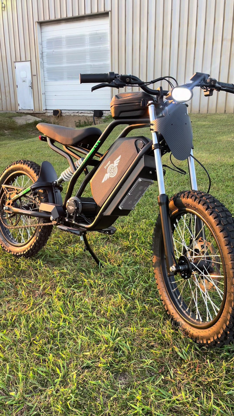 Electric bike with brown seat and tires on grass