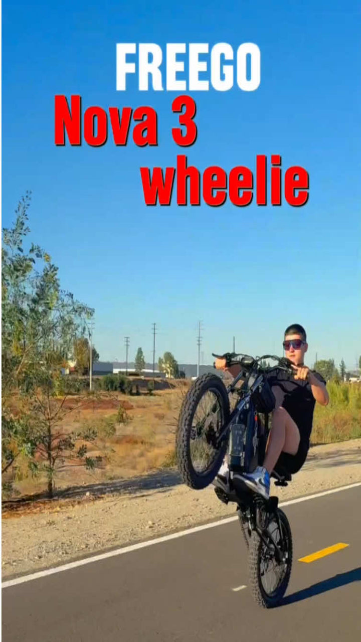Person performing a wheelie on a bike with 'FREEGO Nova 3 wheelie' text overlay.