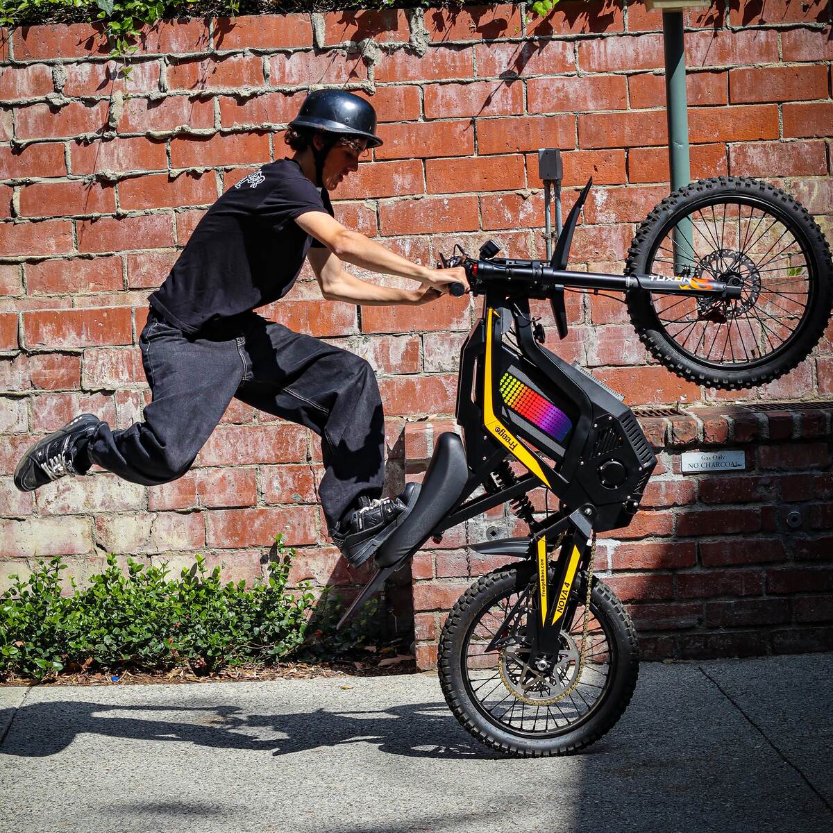 Freego Nova 4 electric bike extreme wheelie action shot with rider airborne