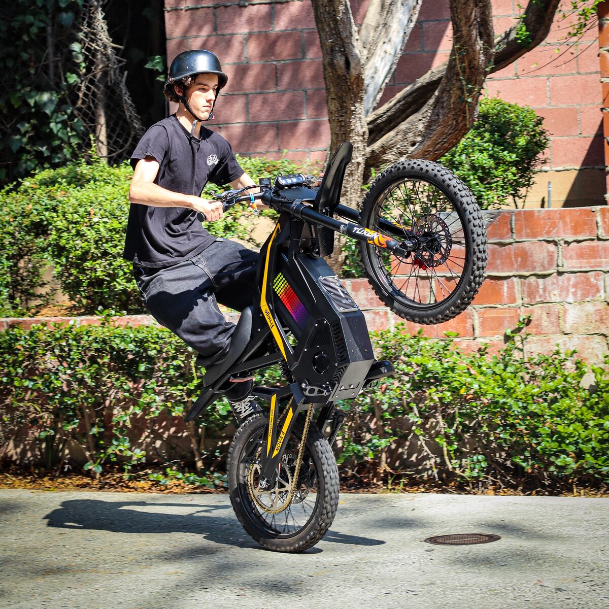 Freego Nova 4 electric bike wheelie front view action shot
