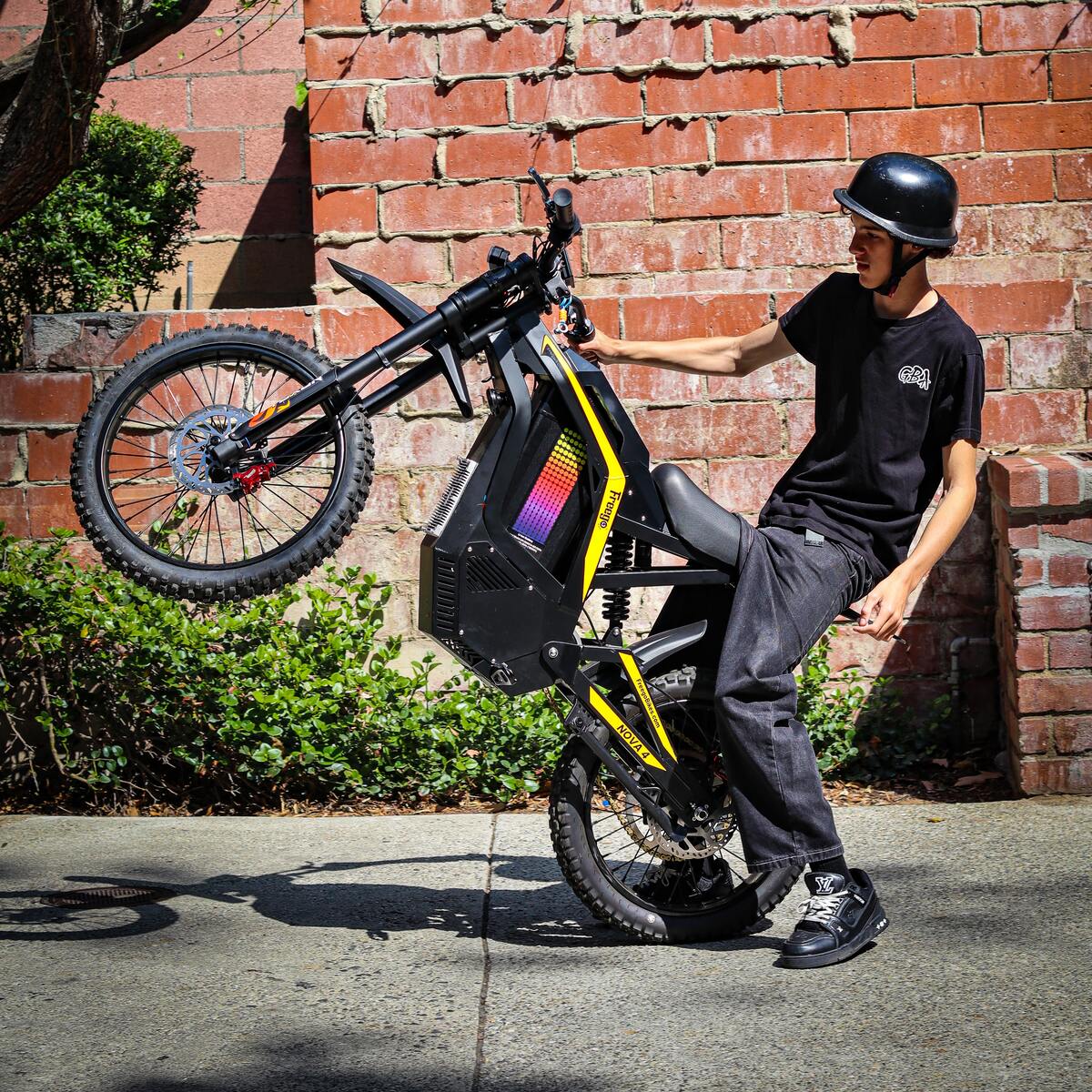 Freego Nova 4 electric bike wheelie profile view action shot