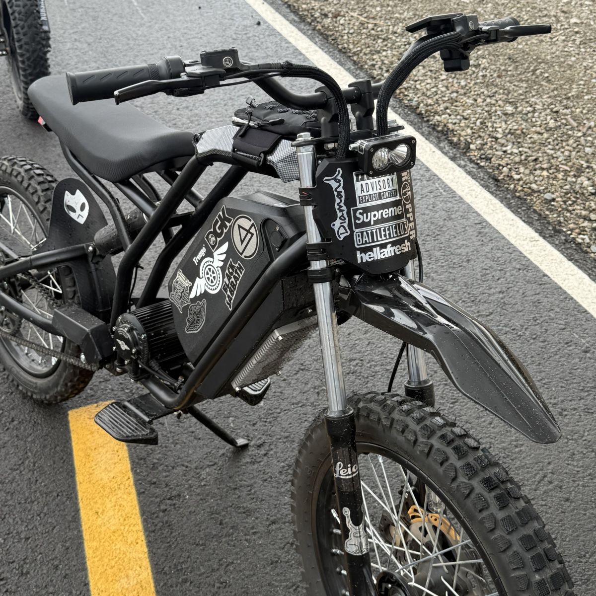 Black electric bike with visible branding on a road
