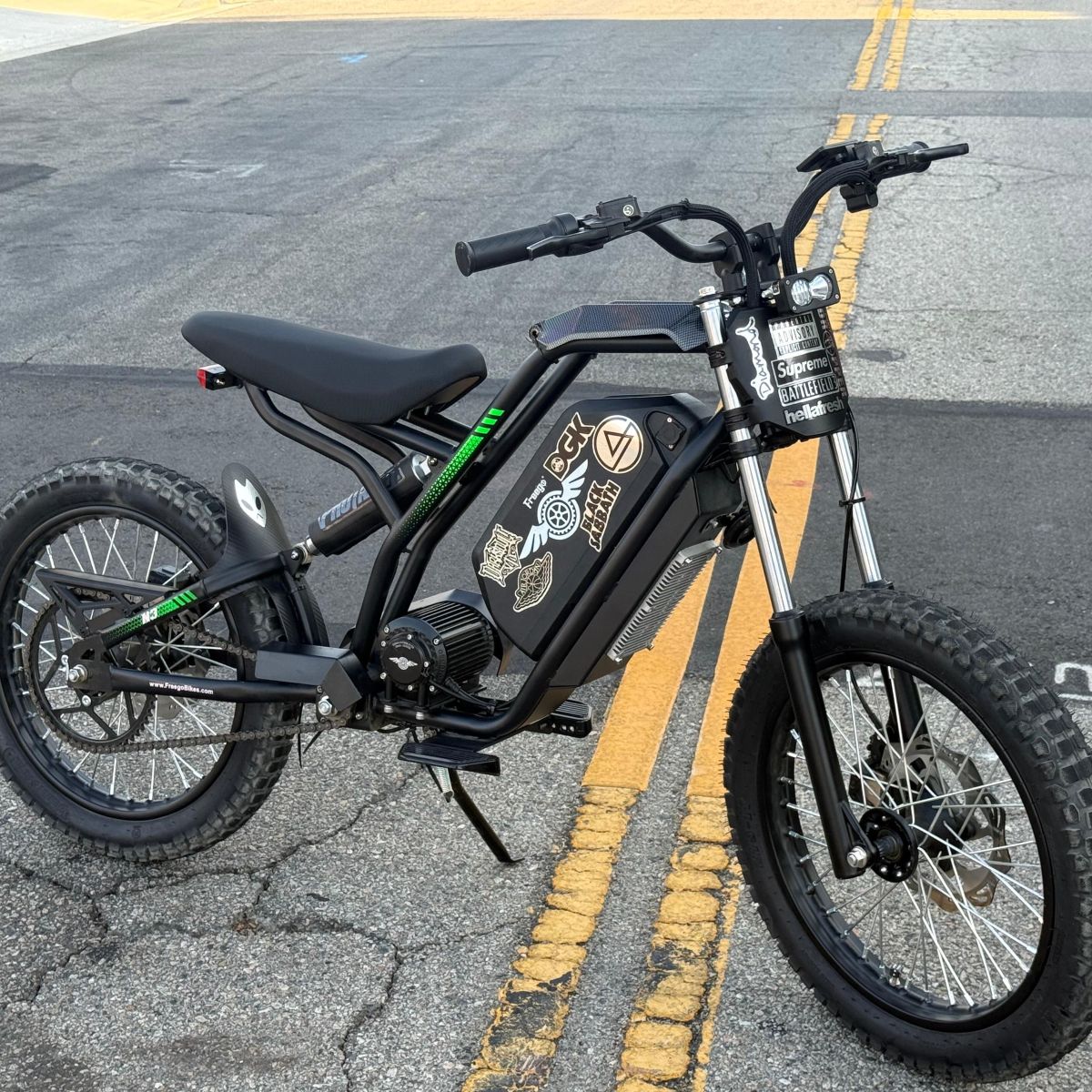 Black electric bike on a road with visible branding