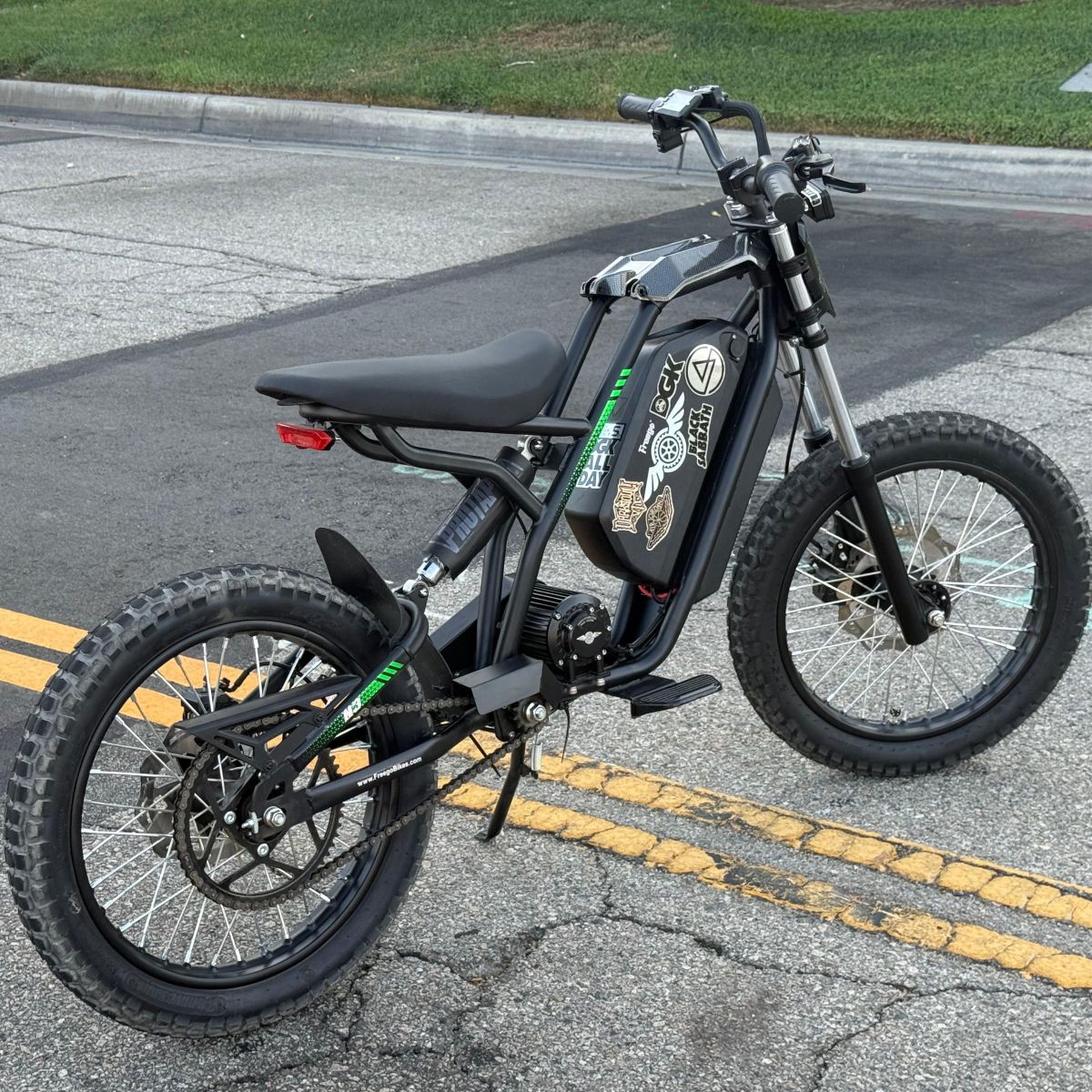 Black electric bike on a road with visible branding